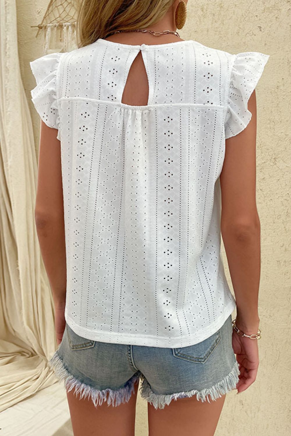 A stylish Eyelet V-Neck Butterfly Sleeve Top featuring elegant eyelet detailing and butterfly cap sleeves, perfect for casual chic outfits.