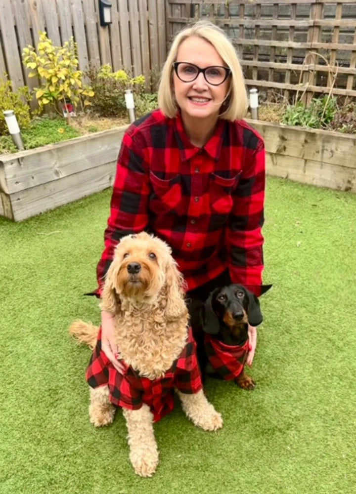 A family wearing matching flannel shirts with their dogs, showcasing the cozy and stylish design of the pet shirts.