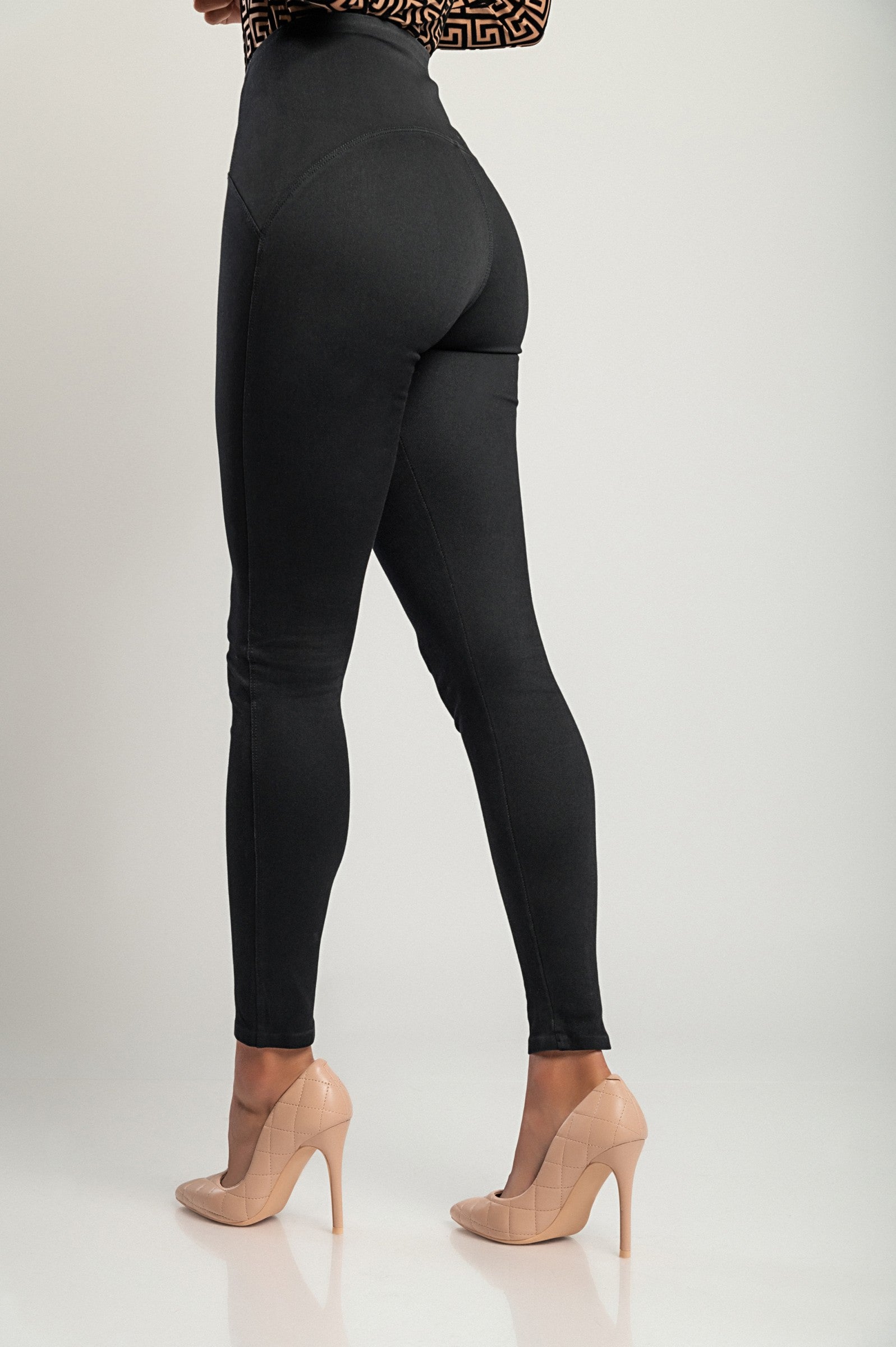 A pair of black fashion leggings with a wide elastic waist, showcasing their soft and stretchy fabric, designed for comfort and style.