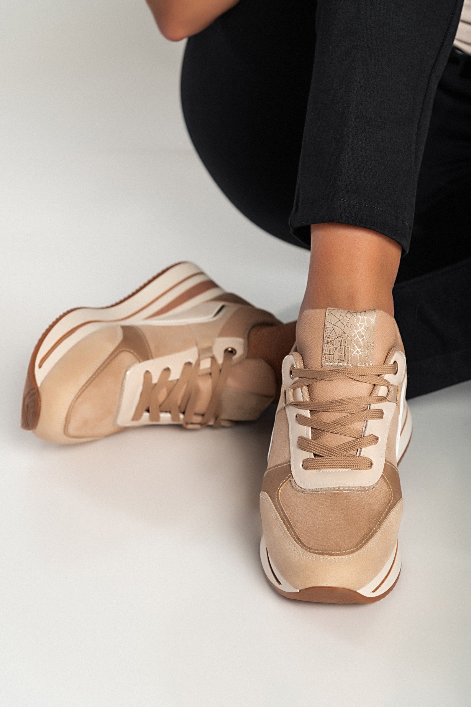 Multicolor fashion sneakers in camel color with raised sole and lace-up closure, showcasing faux leather and textile materials.