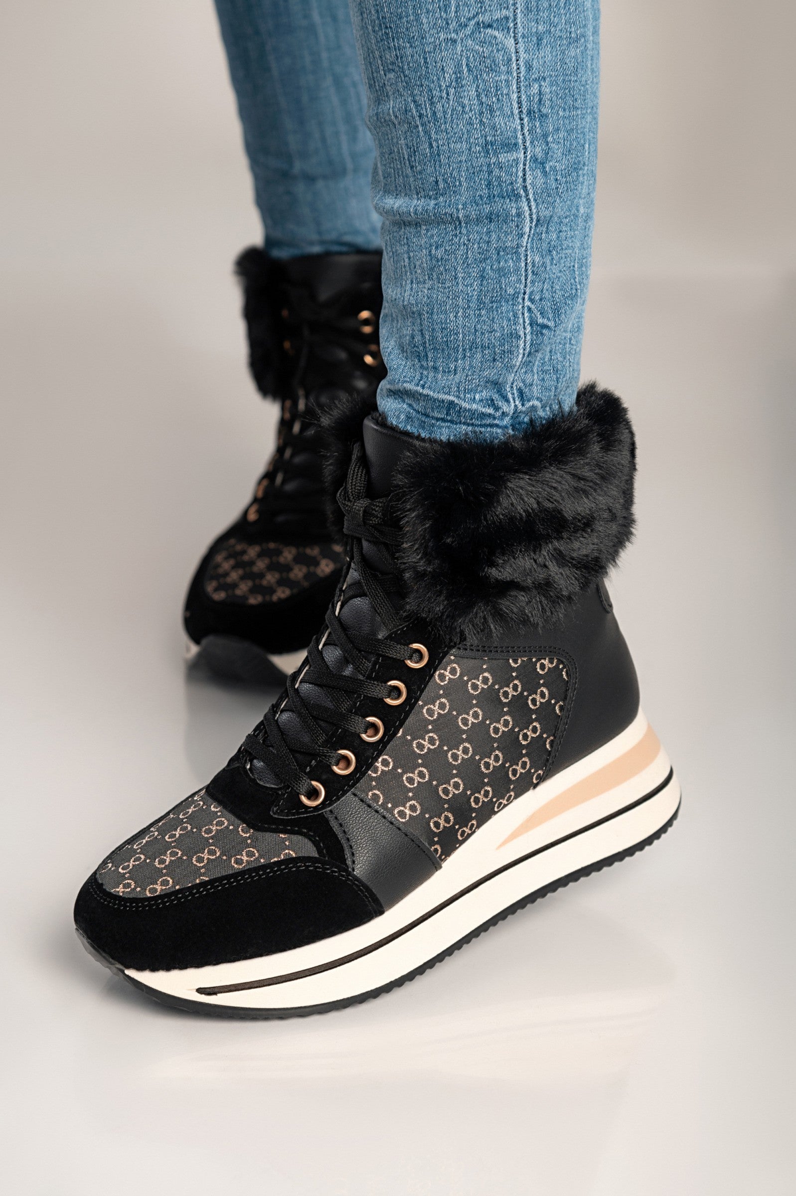 Stylish black faux leather and textile sneakers Alreya with bows and faux fur around the ankle.