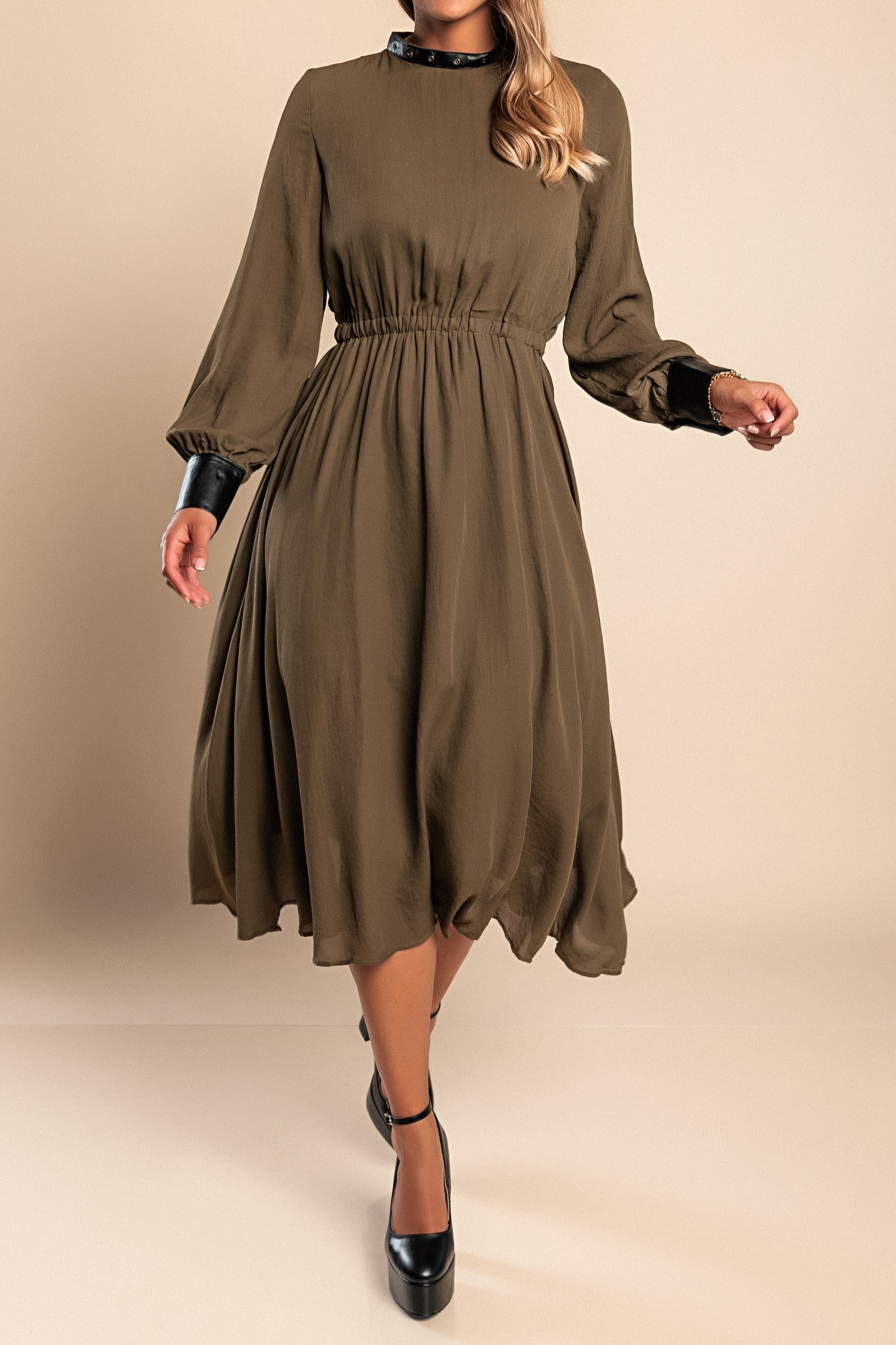 Elegant olive green midi dress with faux leather details, featuring a round neckline, long sleeves, and an elastic waist.