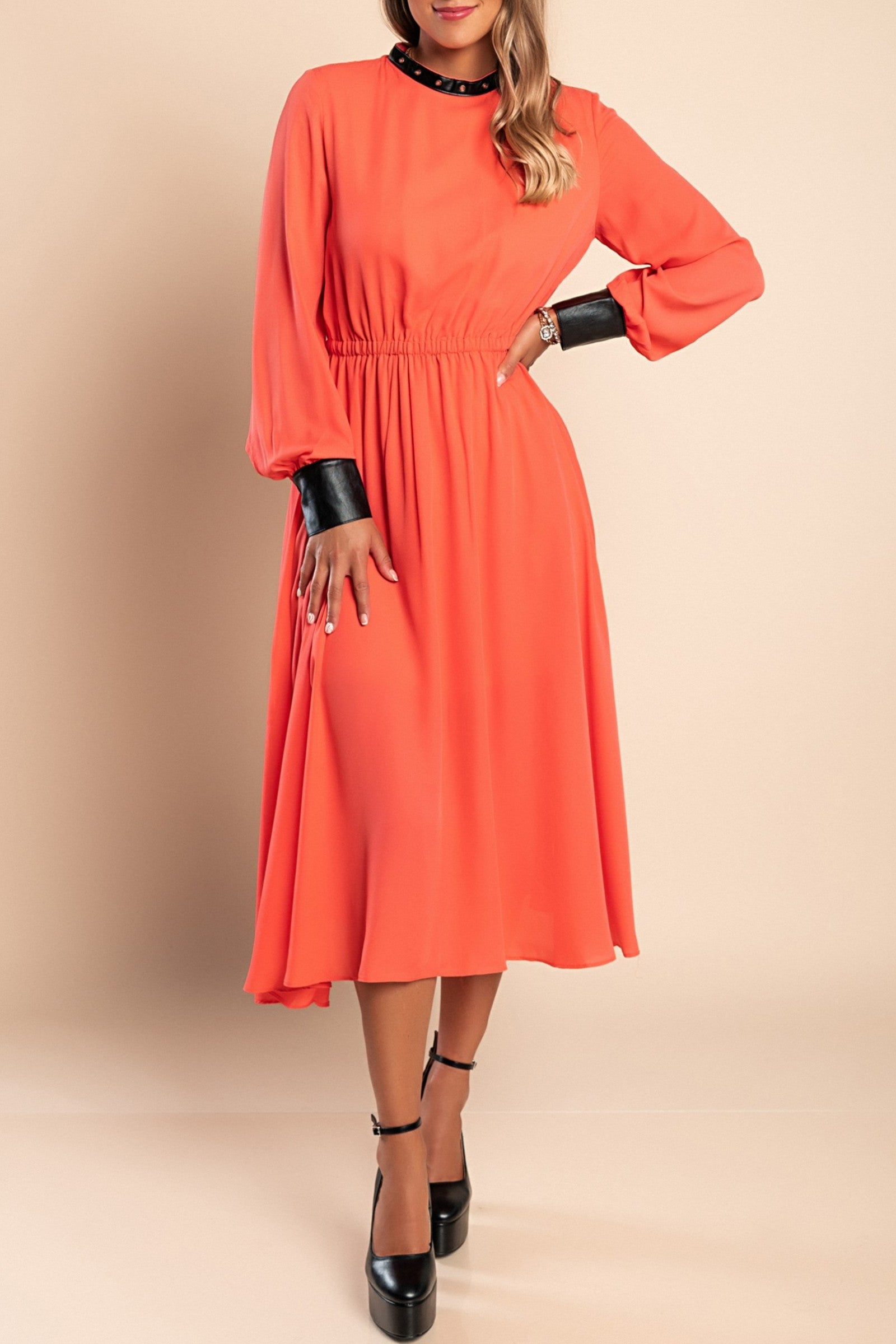 Elegant pink midi dress with faux leather details, featuring a round neckline, long sleeves, and an elastic waist.