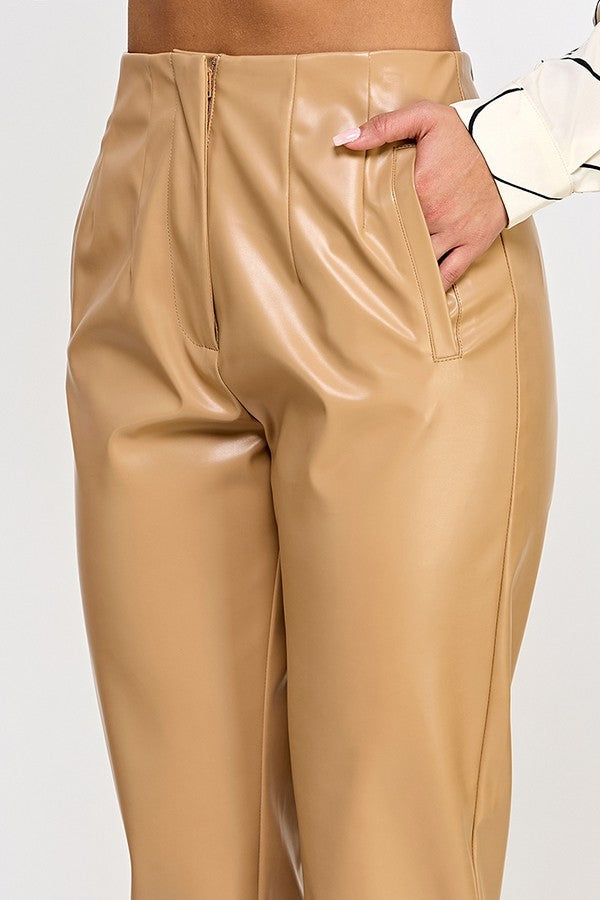 Chic beige faux leather pants displayed on a hanger, showcasing their sleek design and modern style.