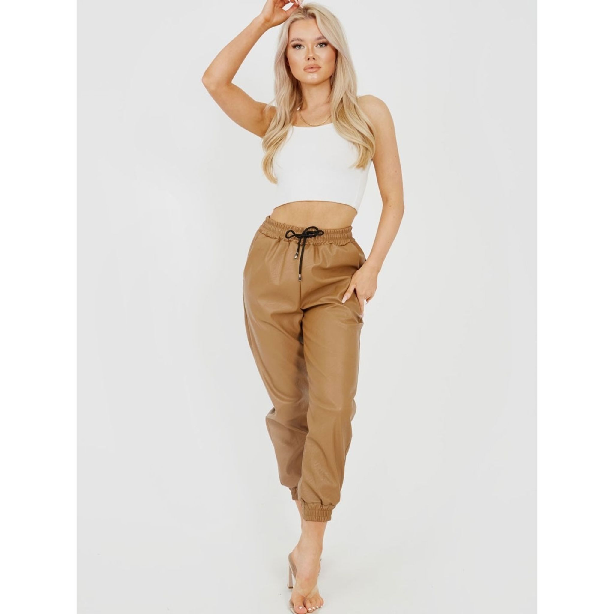 Stylish camel faux leather PU joggers with elasticated waist and cuffs, featuring a functional drawstring.