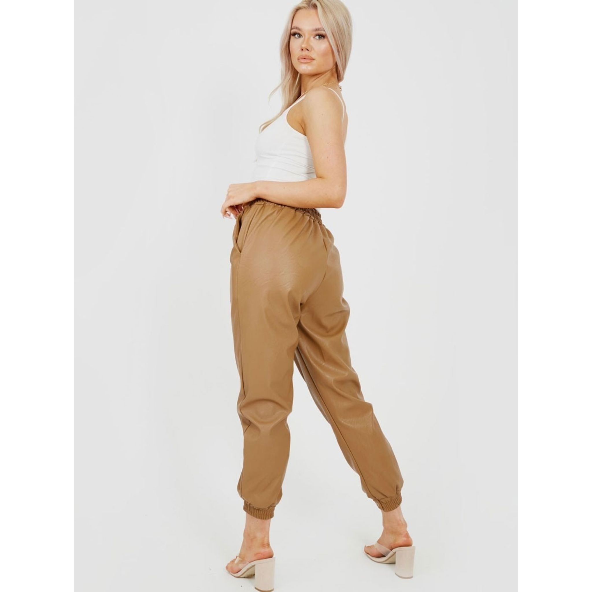 Stylish camel faux leather PU joggers with elasticated waist and cuffs, featuring a functional drawstring.