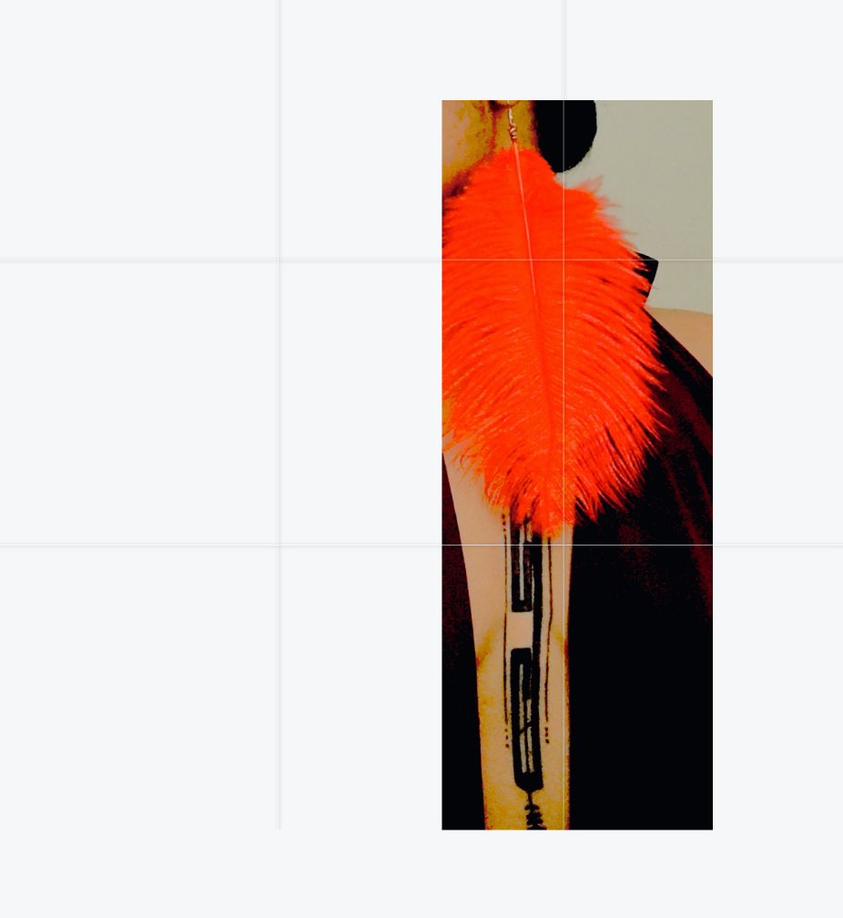 A pair of vibrant red faux shaggy feather single earrings with a fluffy design and fish-hook closure, handmade in LA.