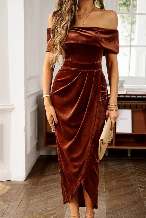 Brown faux velvet midi dress featuring a boat neckline and long sleeves, designed with a fitted model and wrap skirt for a stylish look.