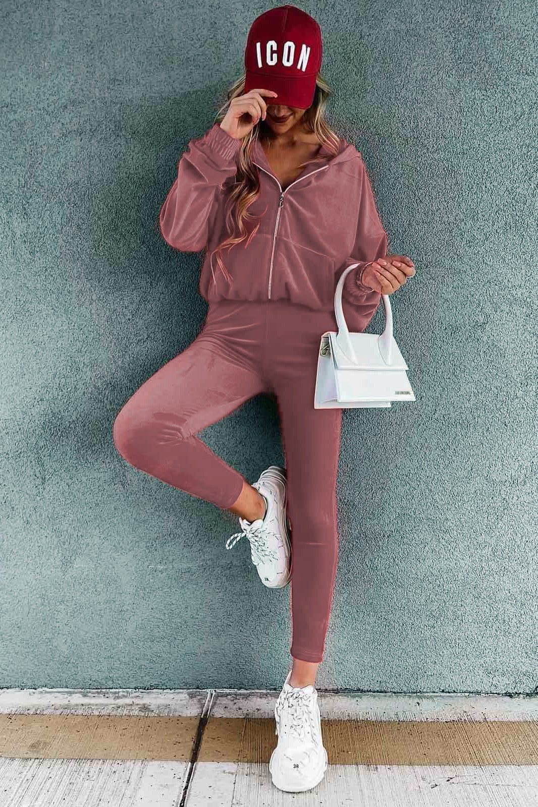 Light pink faux velvet tracksuit set Iberia featuring a hooded jacket and fitted trousers, showcasing soft and stretchy fabric.