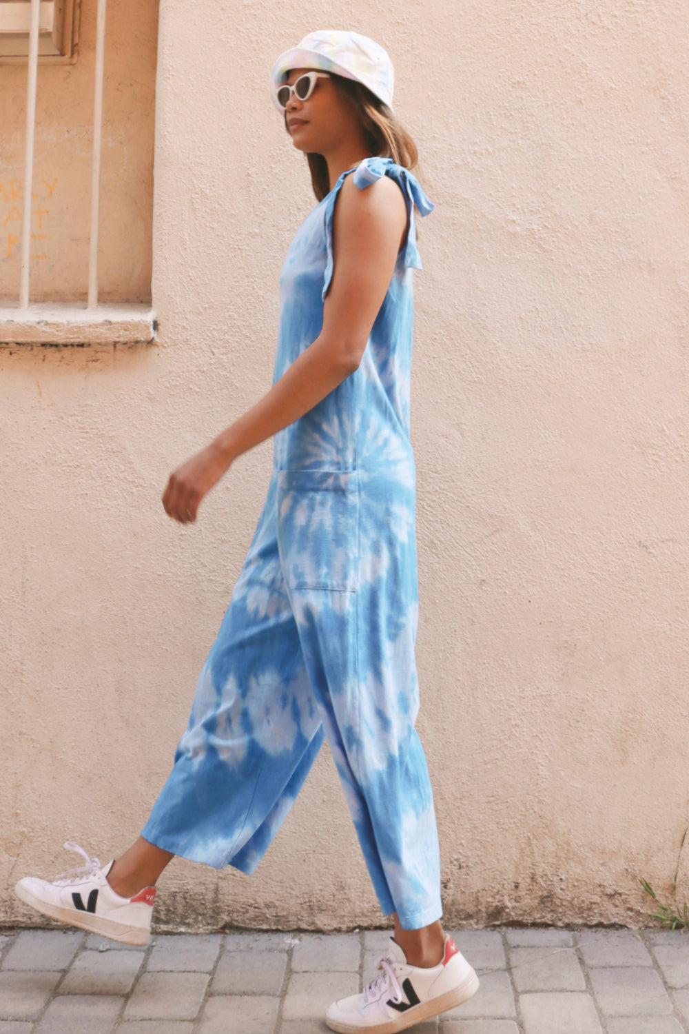 Faye Jumpsuit Tie-Dye in blue, featuring adjustable straps and a stylish design, perfect for layering or wearing alone.