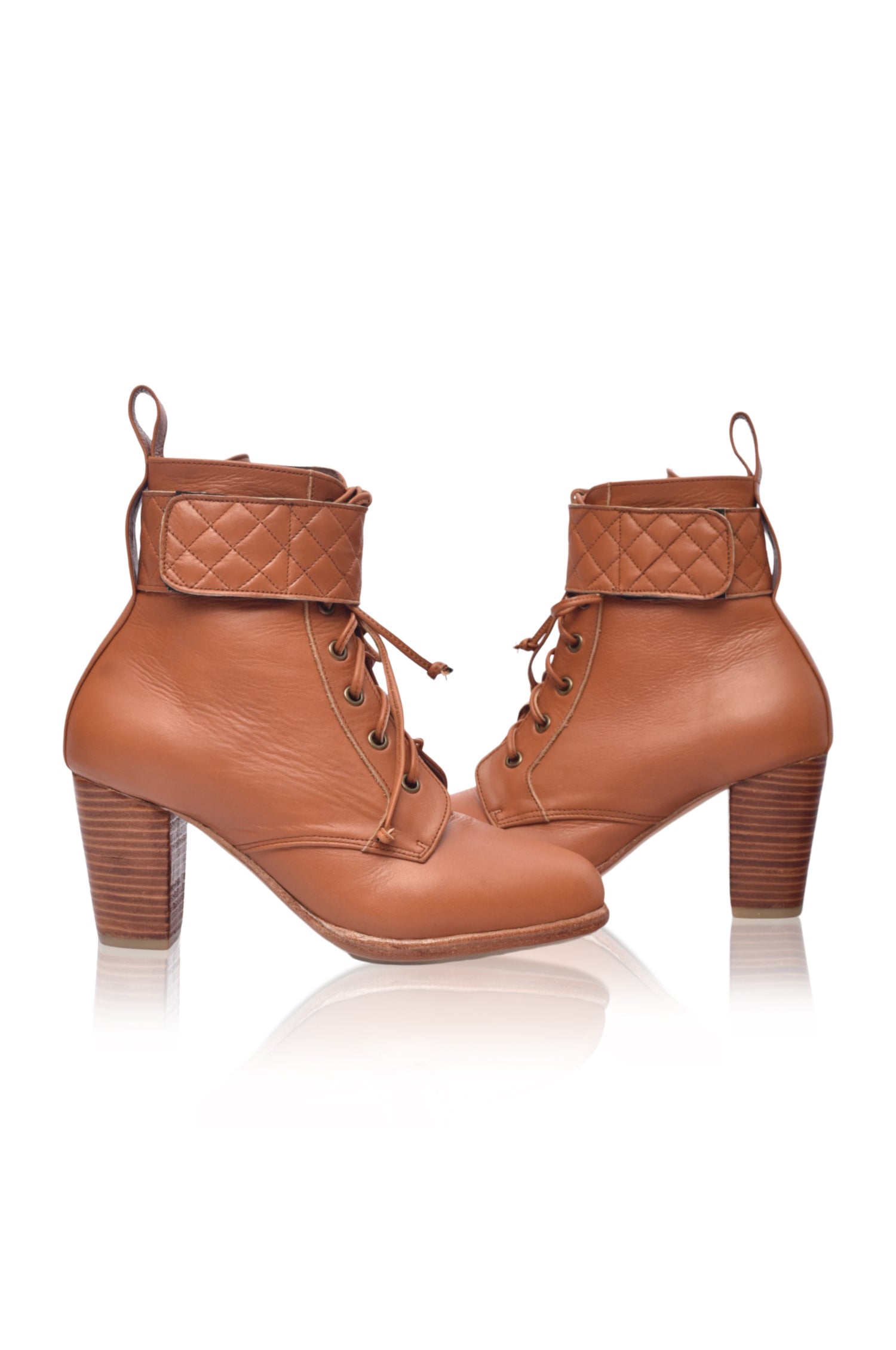 Fine Lover leather booties featuring a lace-up design, chunky wooden heel, and smooth leather finish, perfect for stylish outfits.