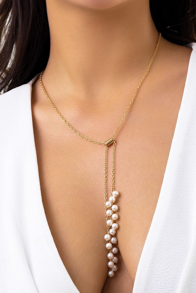 Elegant gold necklace adorned with imitation pearls, featuring a secure metal carabiner closure.