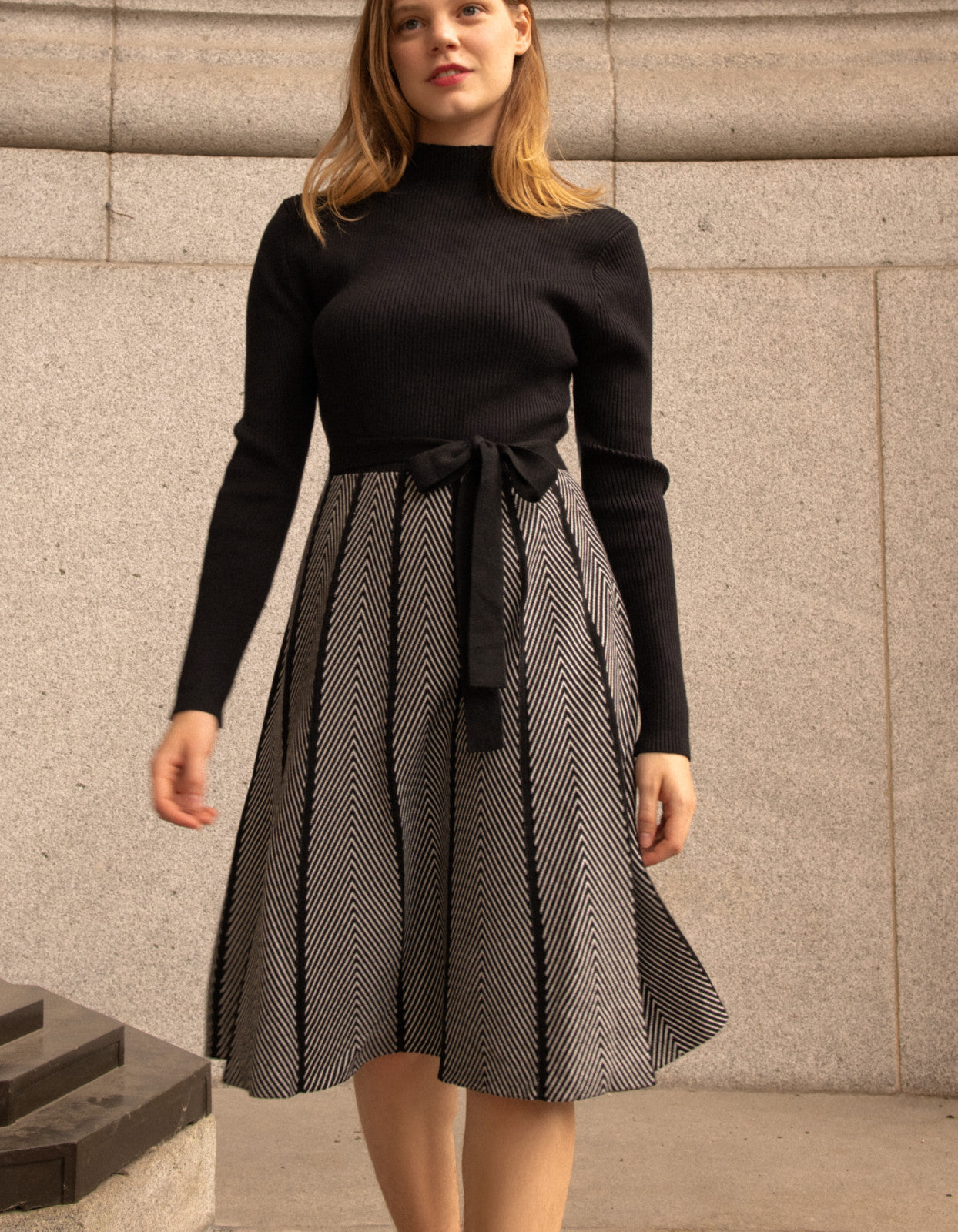 Fiola Dress featuring a solid black ribbed top and herringbone knit skirt, showcasing a stylish winter outfit.