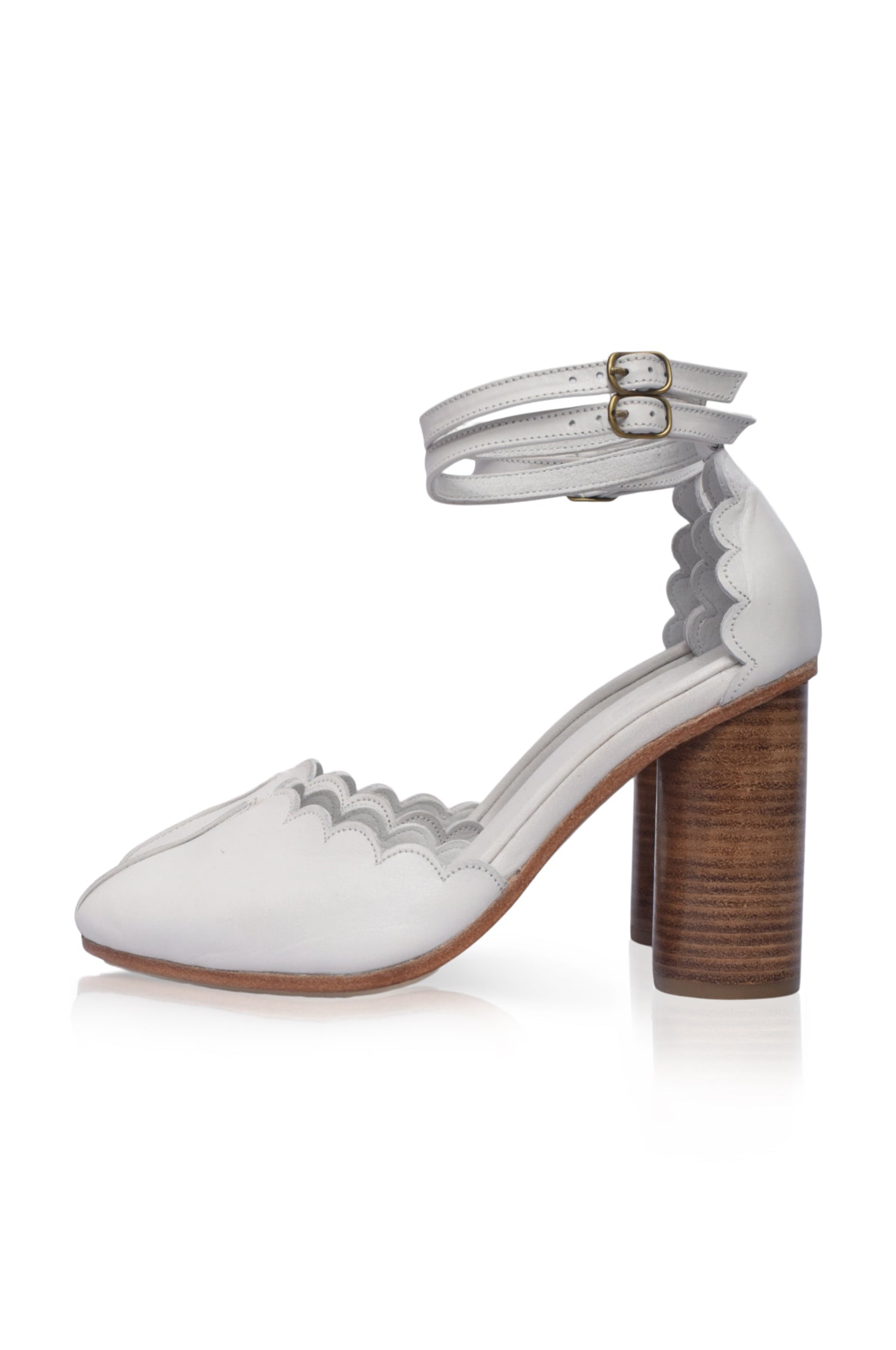 A pair of elegant Flamingo Leather Heels featuring a closed toe design, dual ankle straps, and a hand-cut wooden heel, showcasing their luxurious craftsmanship.