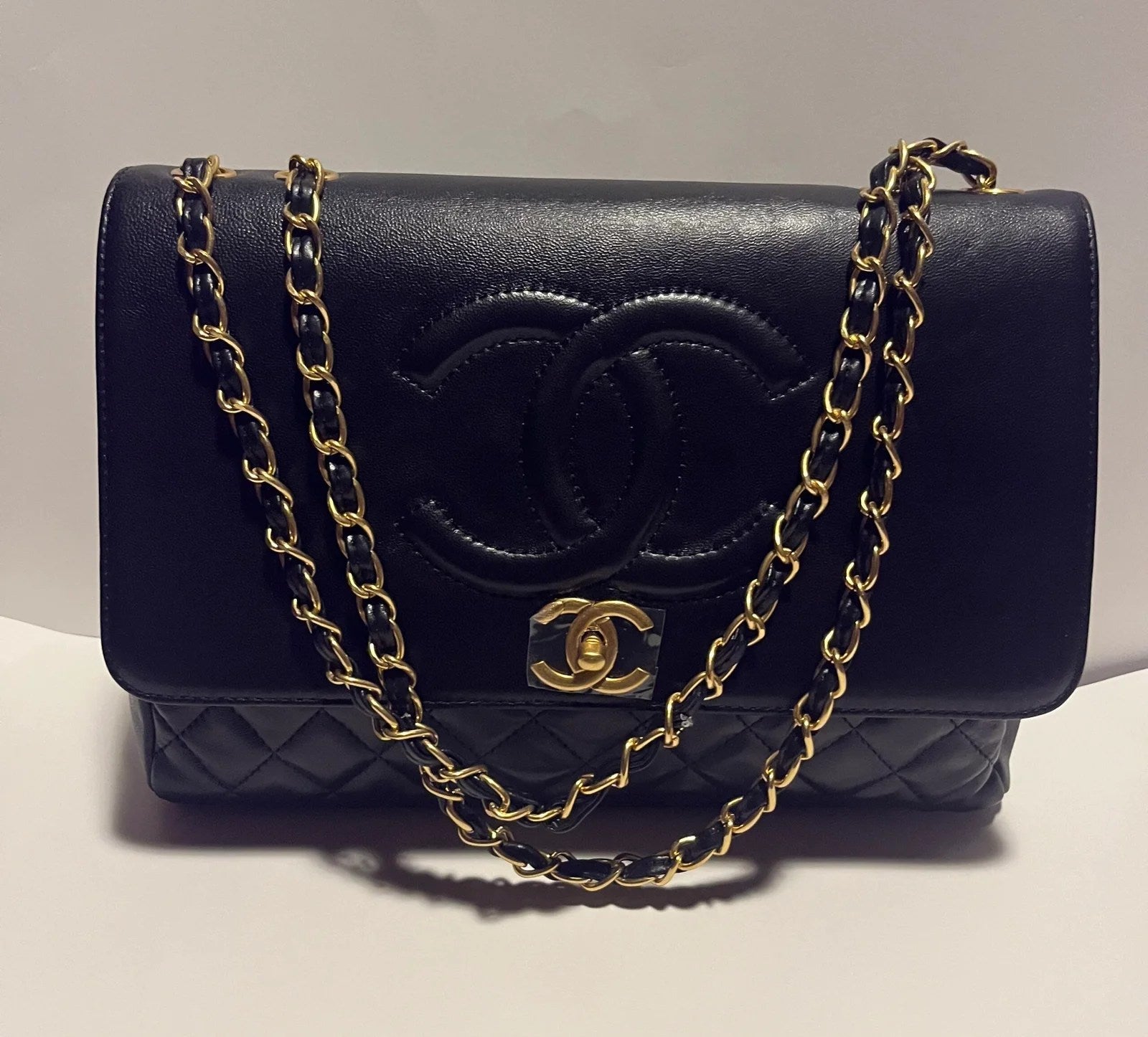 Flap with Top Black Lux Bag featuring gold CC clasp and spacious interior design.