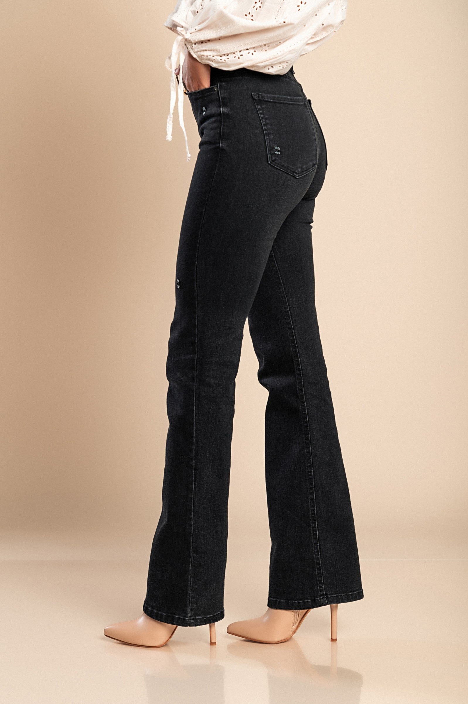 Stylish black flared jeans made from high-quality cotton, featuring a high waist, flared legs, and front and back pockets.