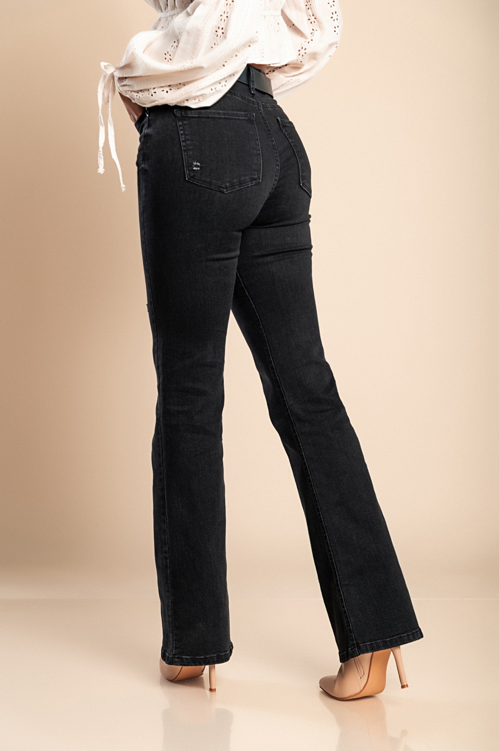 Stylish black flared jeans made from high-quality cotton, featuring a high waist, flared legs, and front and back pockets.