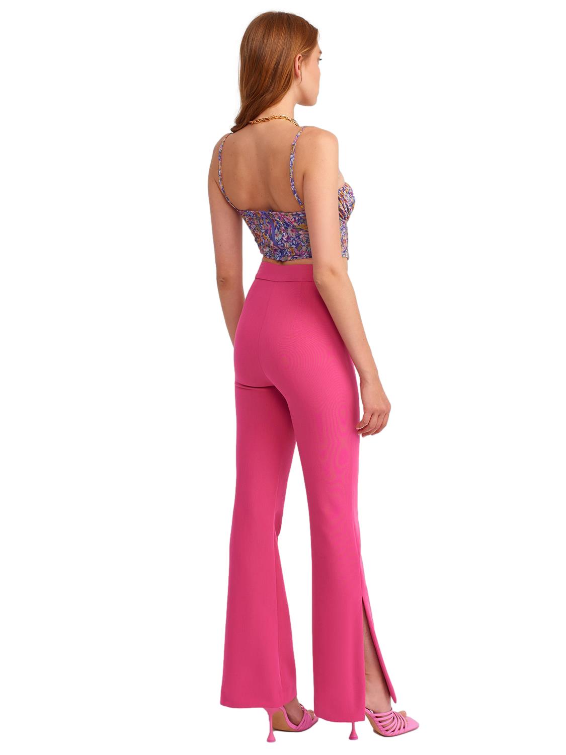 A pair of stylish flared trousers with slits on the sides, made from a comfortable blend of polyester, viscose, and elastane, displayed on a mannequin.