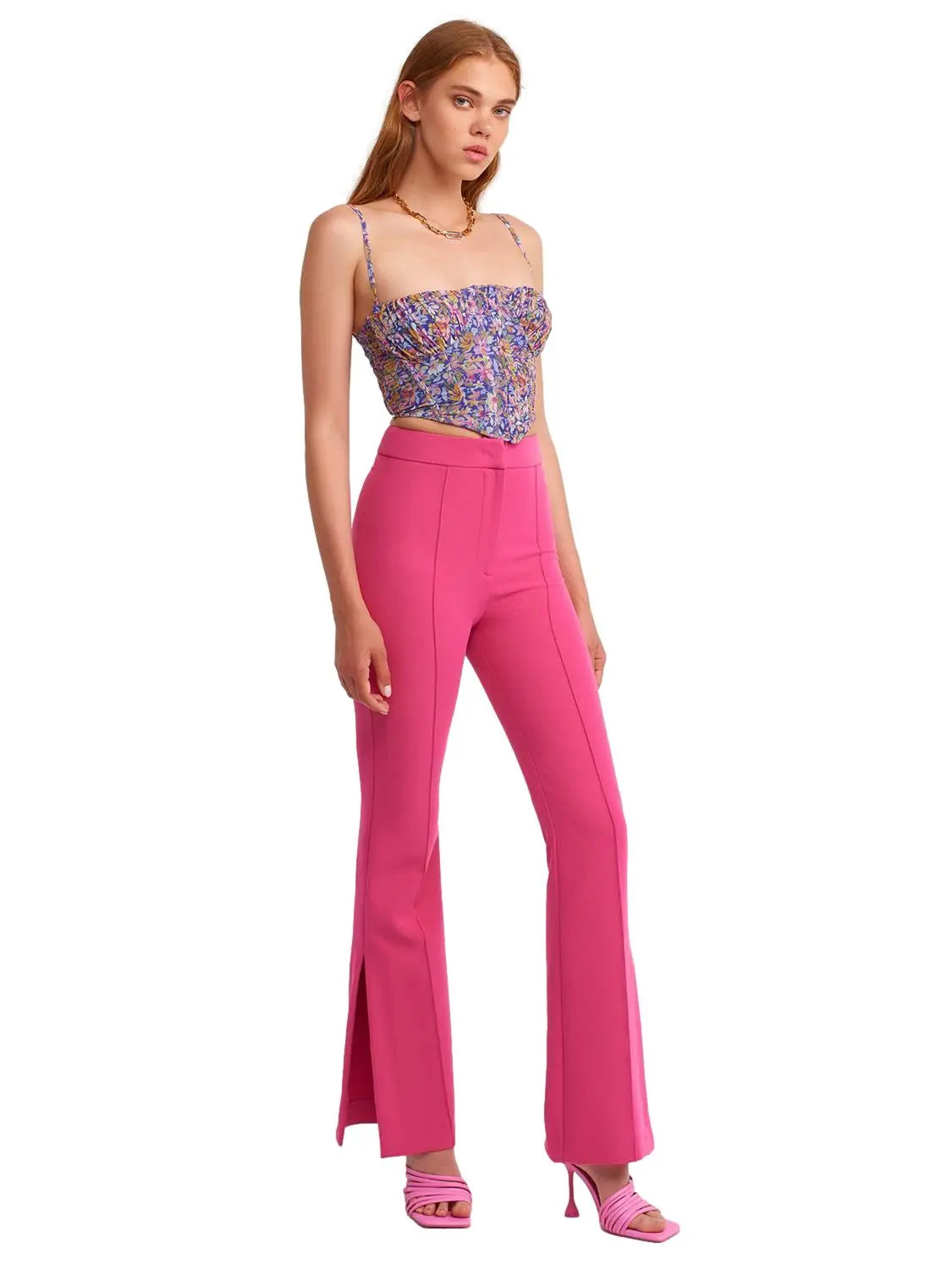 A pair of stylish flared trousers with slits on the sides, made from a comfortable blend of polyester, viscose, and elastane, displayed on a mannequin.