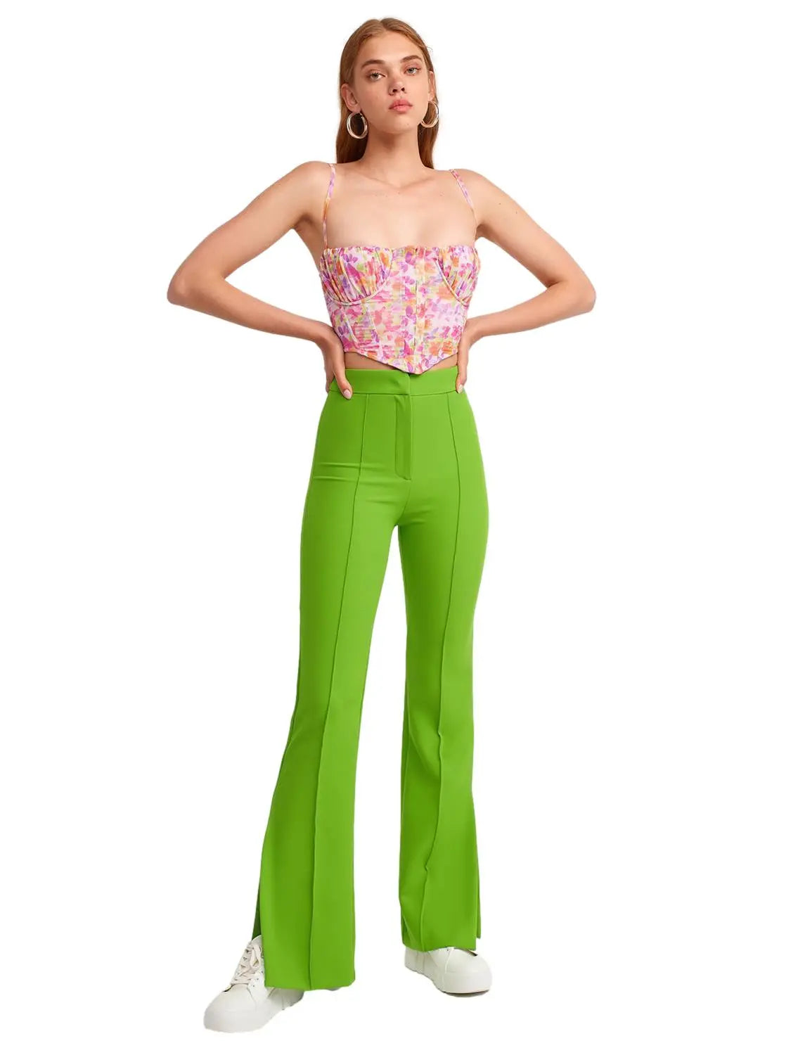 A pair of stylish flared trousers with slits on the sides, made from a comfortable blend of polyester, viscose, and elastane, displayed on a mannequin.