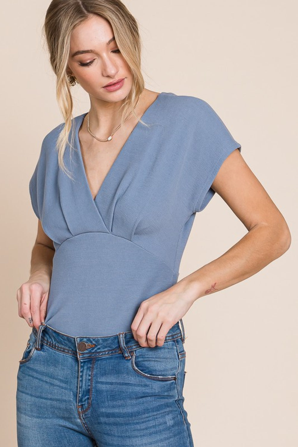 Flatter Me Thermal V-Neck Bodysuit featuring a plunge neckline and short sleeves, designed for a flattering fit and stylish look.