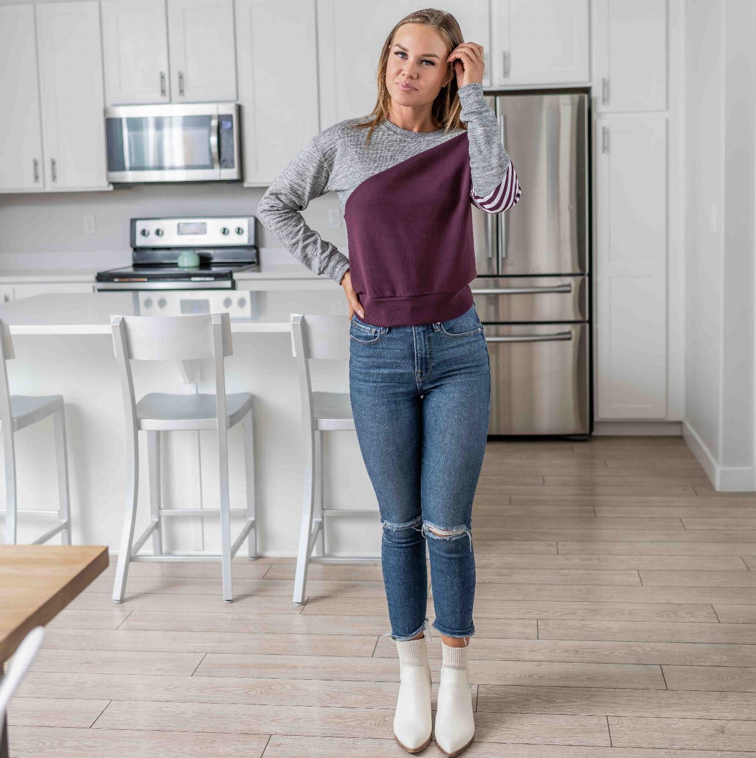 Fleece Color Block Crop Tee featuring asymmetrical color blocking and striped sleeve design in plum and grey.