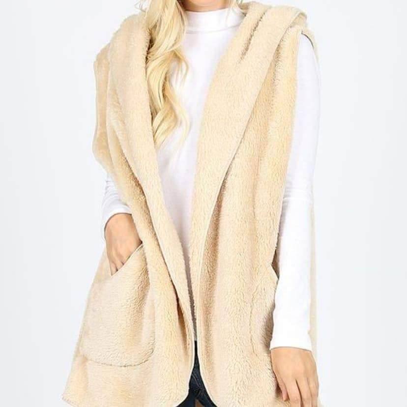 A cozy fleece hooded vest in soft faux fur with side pockets, perfect for layering in colder weather.