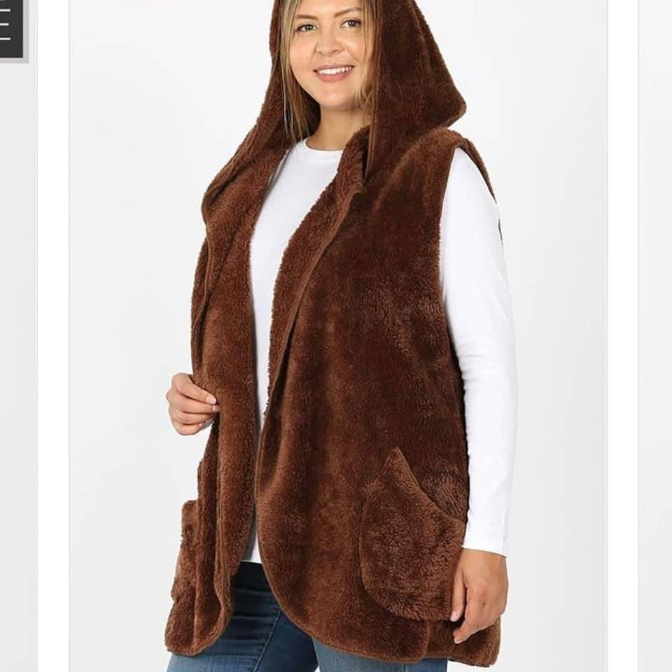 A cozy fleece hooded vest in soft faux fur with side pockets, perfect for layering in colder weather.