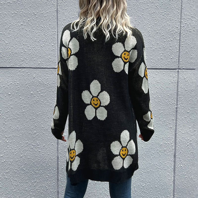 Floral Button Down Longline Cardigan displayed outdoors, featuring a vibrant floral pattern and long sleeves.