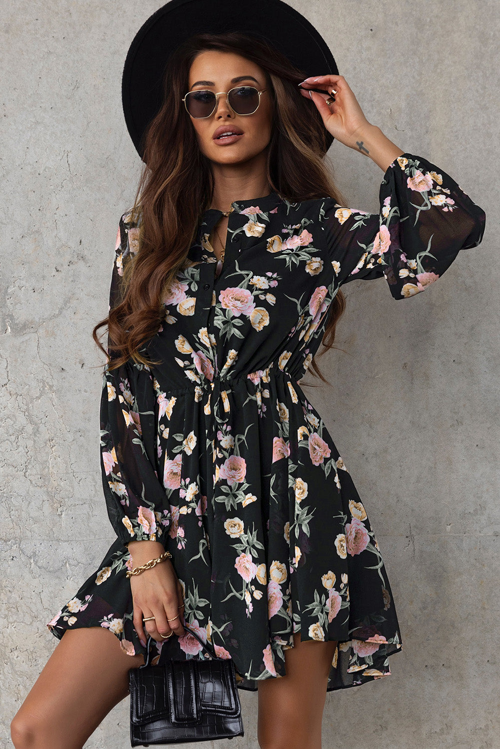 A stylish Floral Buttoned Puff Sleeve Tiered Dress featuring a floral pattern, balloon sleeves, and a mini length, displayed outdoors in a flat lay style.