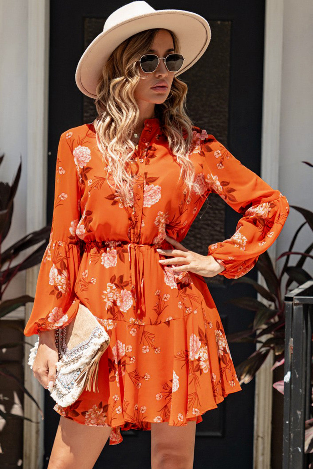 A stylish Floral Buttoned Puff Sleeve Tiered Dress featuring a floral pattern, balloon sleeves, and a mini length, displayed outdoors in a flat lay style.