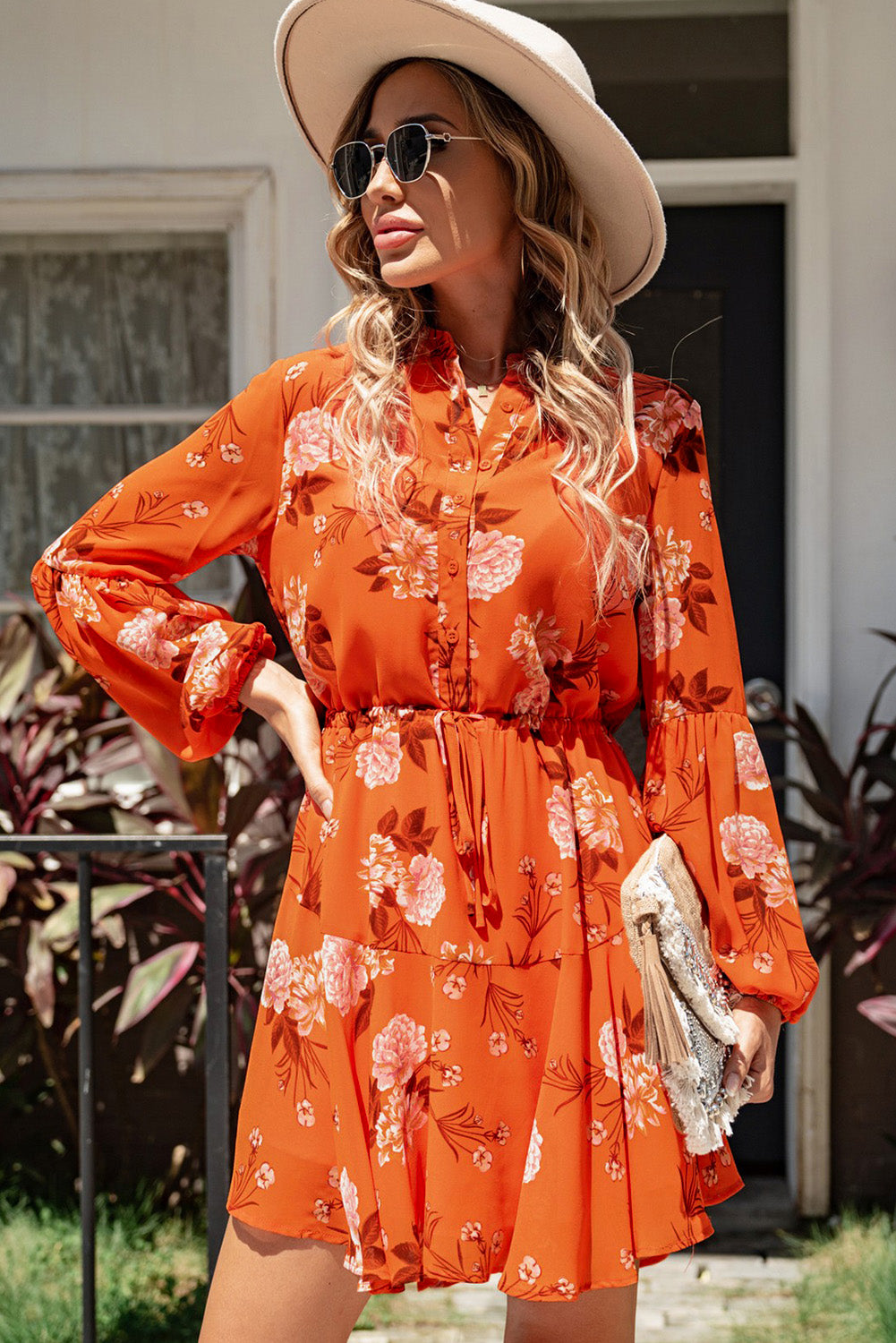 A stylish Floral Buttoned Puff Sleeve Tiered Dress featuring a floral pattern, balloon sleeves, and a mini length, displayed outdoors in a flat lay style.