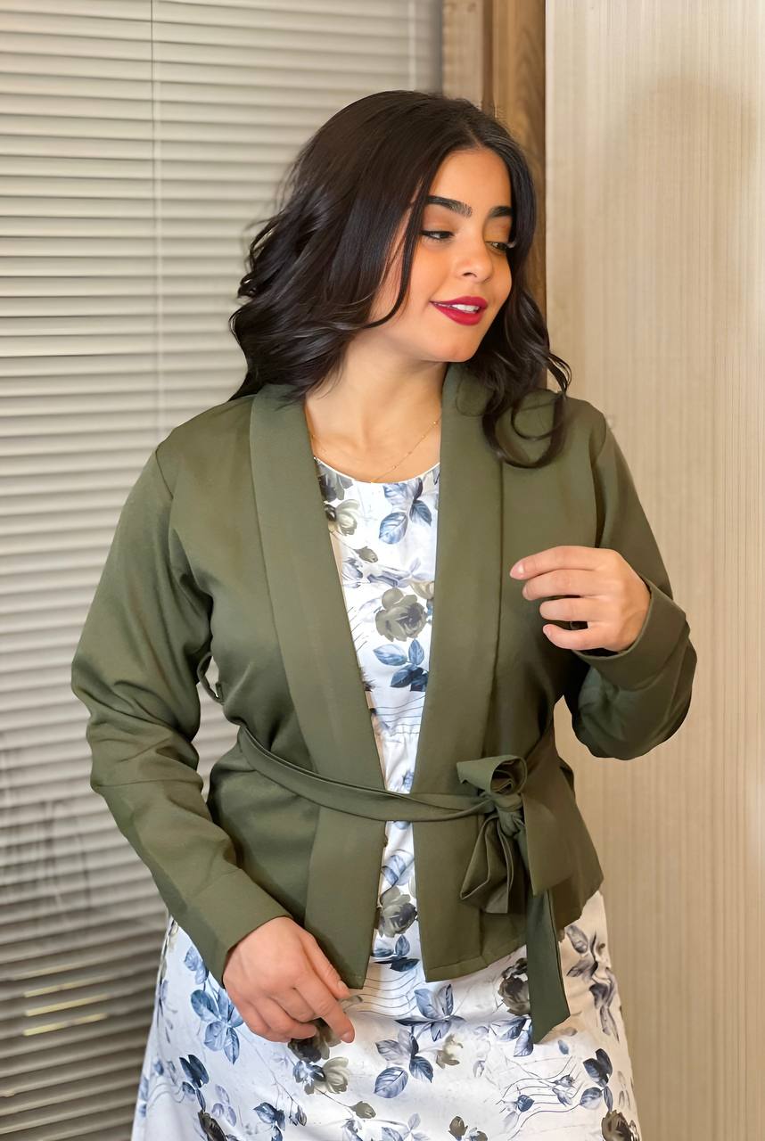 A vibrant floral dress paired with a solid color jacket, showcasing a stylish and versatile outfit.