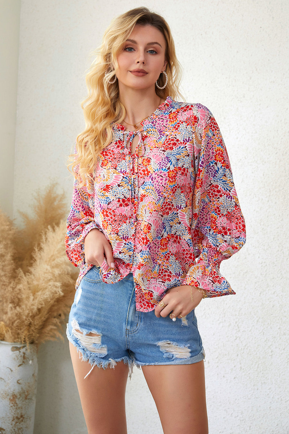 A stylish Floral Frill Trim Tie Neck Flounce Sleeve Blouse featuring a vibrant floral pattern, flounce sleeves, and a chic tie neck design.