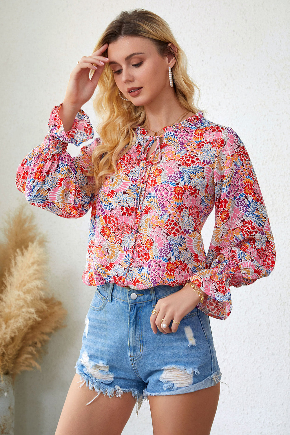 A stylish Floral Frill Trim Tie Neck Flounce Sleeve Blouse featuring a vibrant floral pattern, flounce sleeves, and a chic tie neck design.