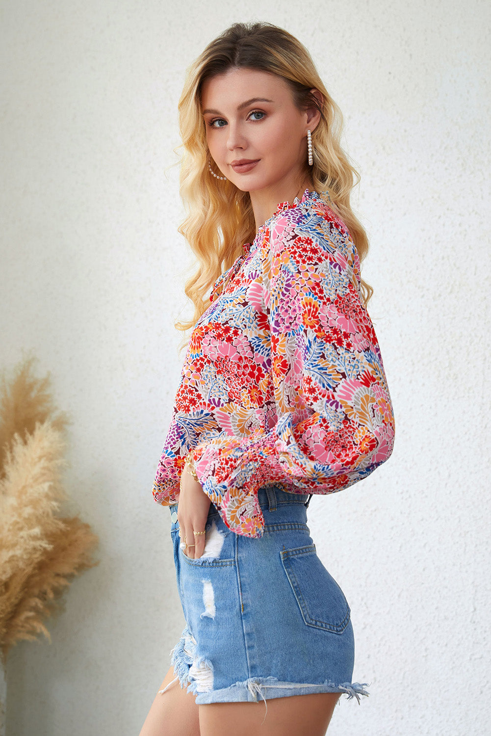 A stylish Floral Frill Trim Tie Neck Flounce Sleeve Blouse featuring a vibrant floral pattern, flounce sleeves, and a chic tie neck design.