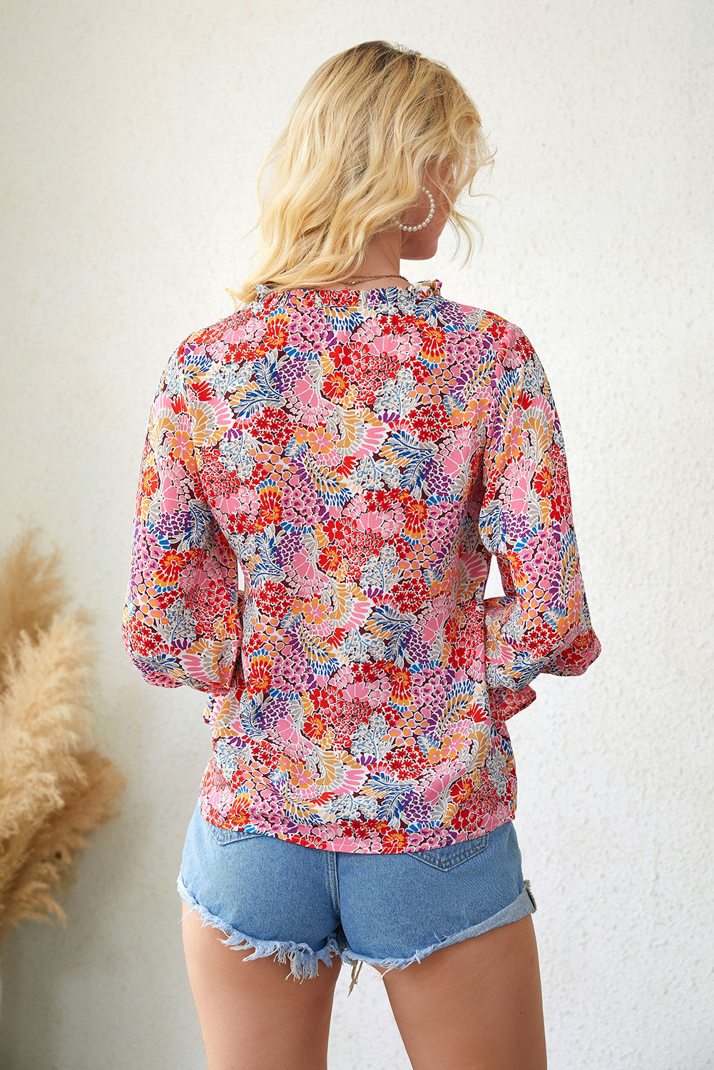 A stylish Floral Frill Trim Tie Neck Flounce Sleeve Blouse featuring a vibrant floral pattern, flounce sleeves, and a chic tie neck design.