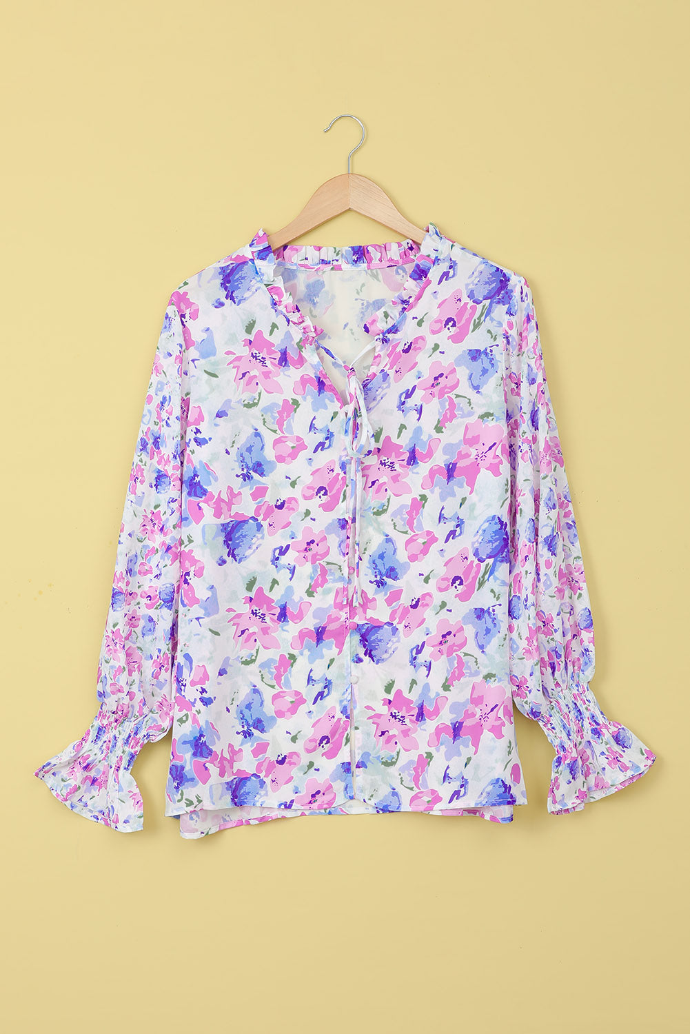 A stylish Floral Frill Trim Tie Neck Flounce Sleeve Blouse featuring a vibrant floral pattern, flounce sleeves, and a chic tie neck design.