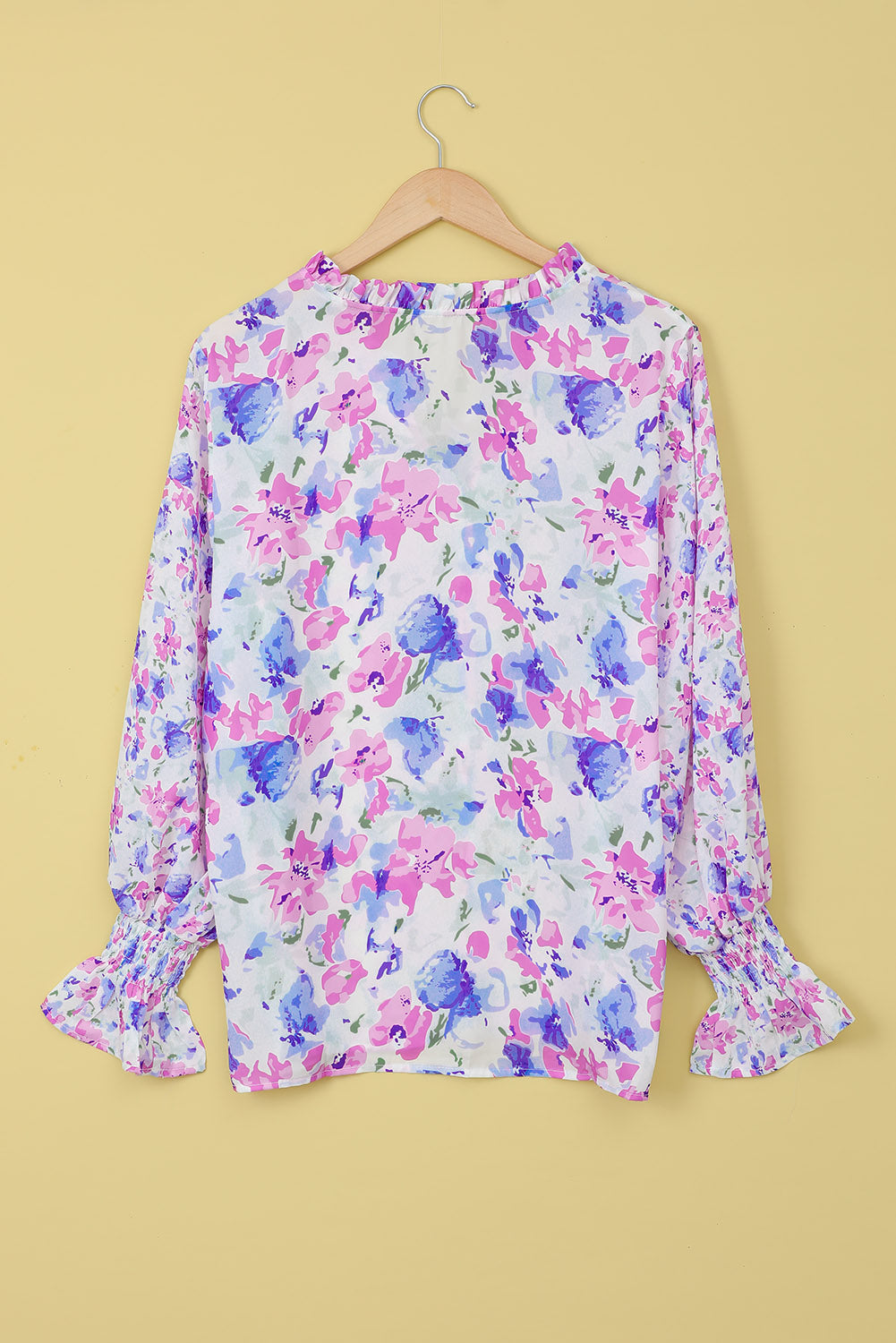 A stylish Floral Frill Trim Tie Neck Flounce Sleeve Blouse featuring a vibrant floral pattern, flounce sleeves, and a chic tie neck design.