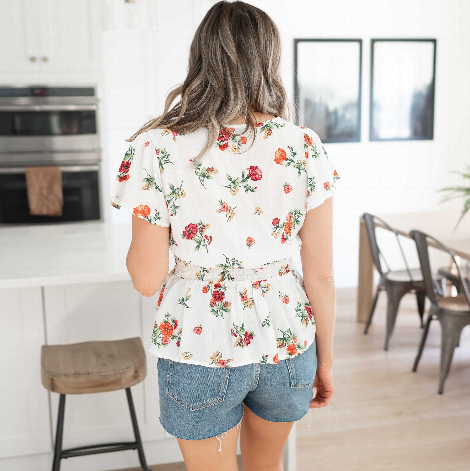 Floral Print Smocked Peplum Waist Top featuring a V-neck and flutter sleeves, adorned with buttercup ditsy florals.