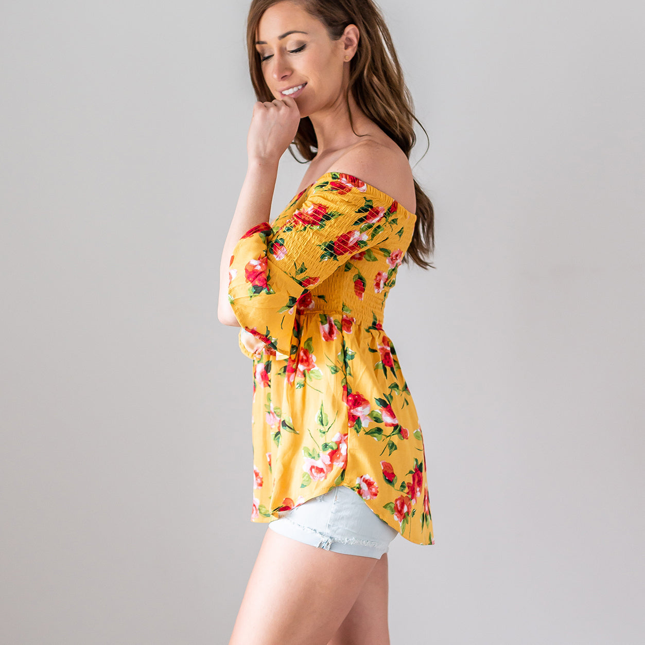 A lightweight floral print top featuring a baby doll silhouette and three-quarter bell sleeves, perfect for spring fashion.