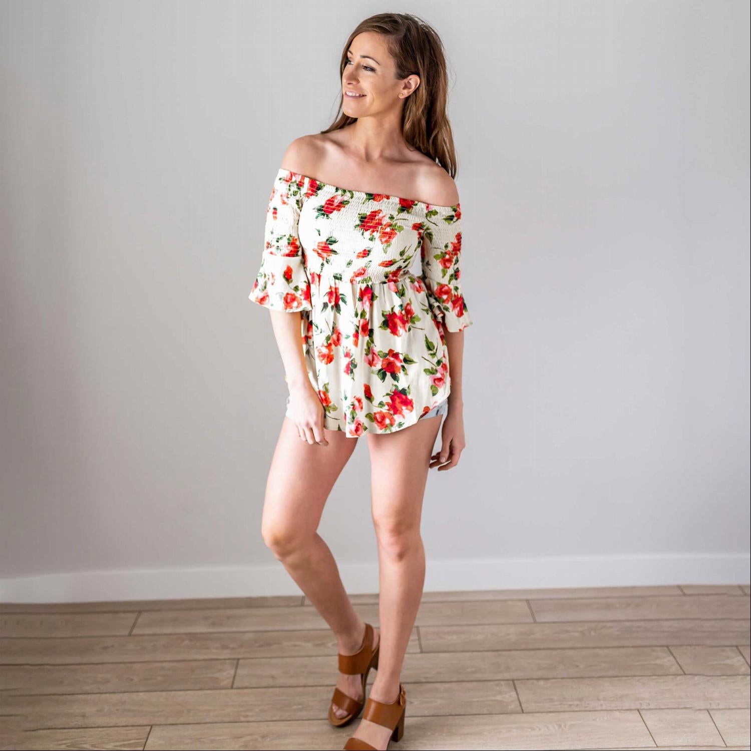 A lightweight floral print top featuring a baby doll silhouette and three-quarter bell sleeves, perfect for spring fashion.