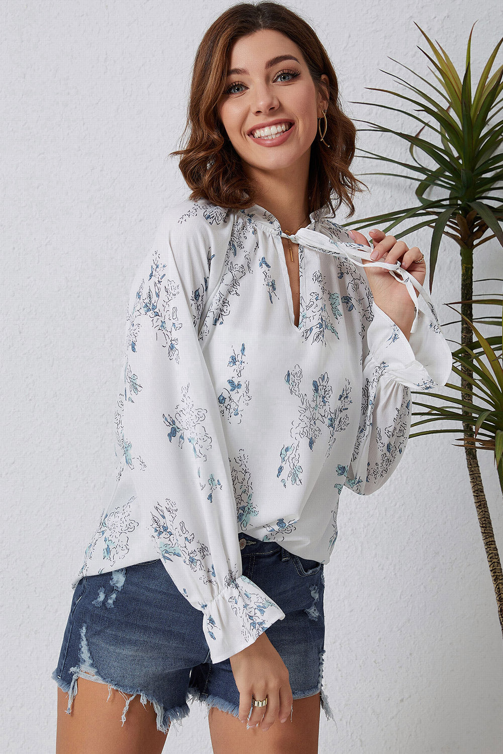 A stylish Floral Tie Neck Crinkle Blouse featuring a vibrant floral print, frilled stand collar, and tie detail, perfect for casual and formal occasions.