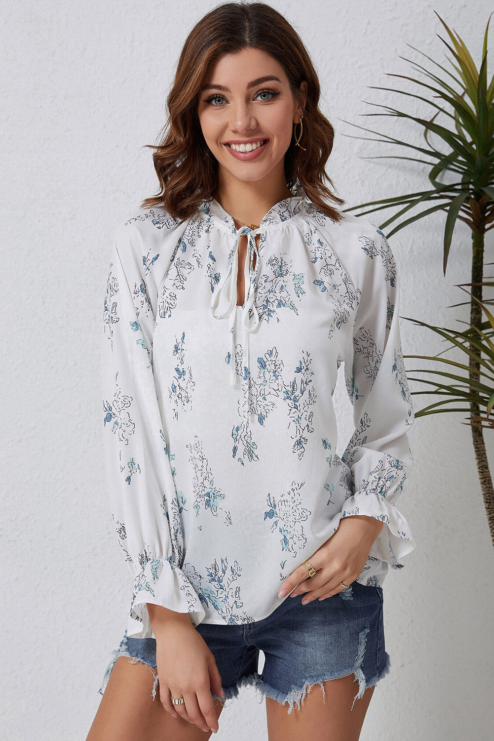 A stylish Floral Tie Neck Crinkle Blouse featuring a vibrant floral print, frilled stand collar, and tie detail, perfect for casual and formal occasions.