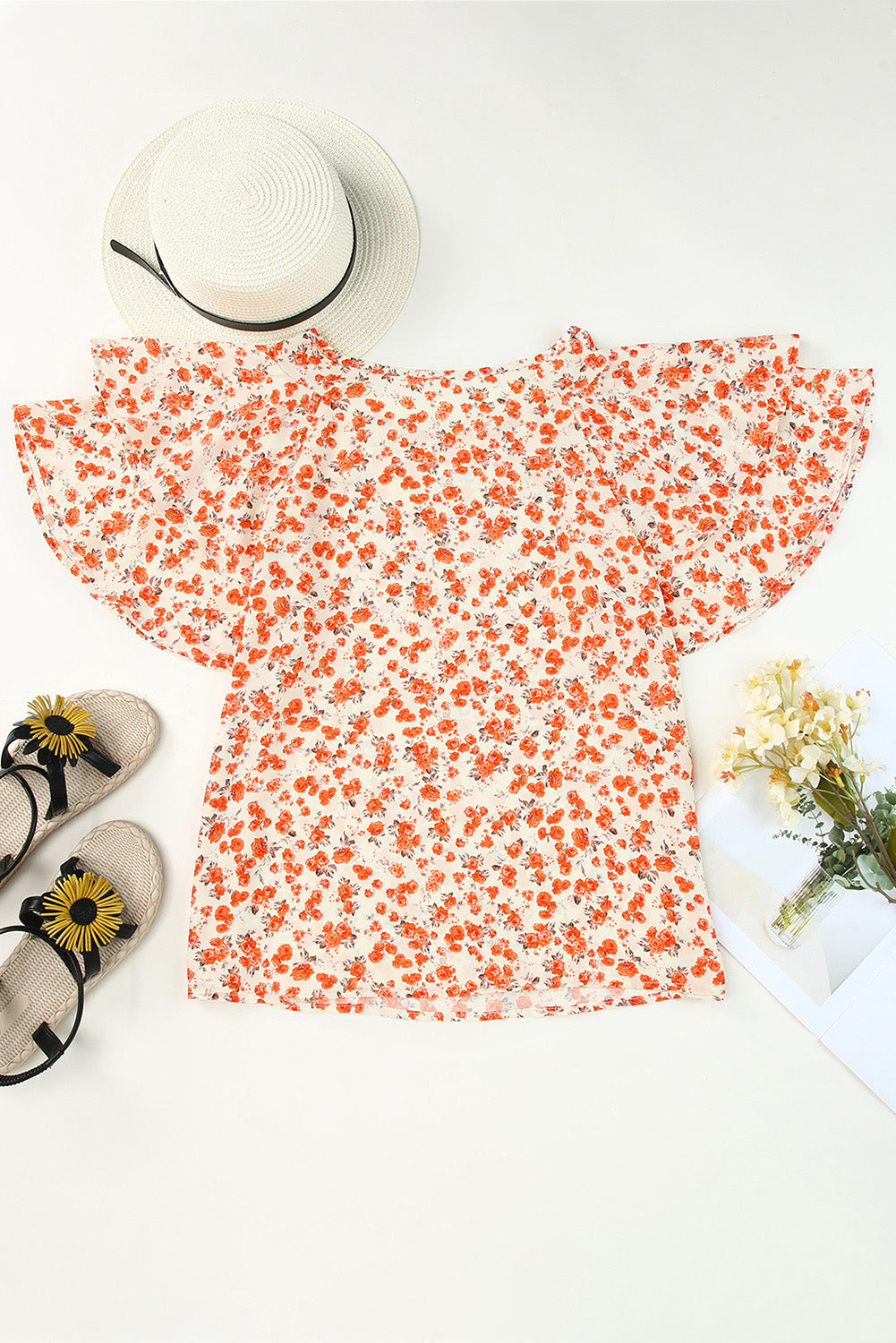 A stylish Floral Tiered Flutter Sleeve Blouse featuring a vibrant floral pattern, flutter sleeves, and a classic crew neckline, perfect for sunny days.