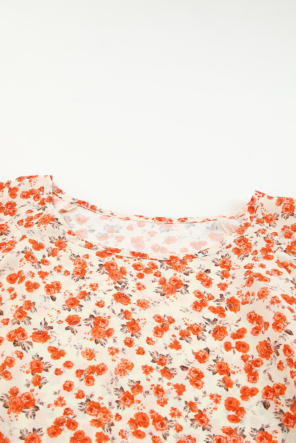 A stylish Floral Tiered Flutter Sleeve Blouse featuring a vibrant floral pattern, flutter sleeves, and a classic crew neckline, perfect for sunny days.