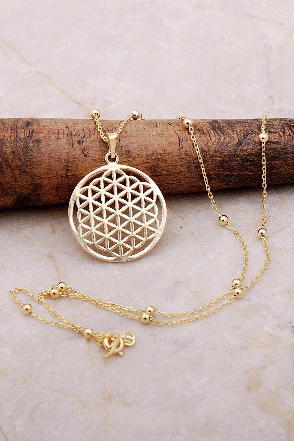 Flower of Life Gold Gilded Silver Necklace featuring intricate design and luxurious gold finish on sterling silver.