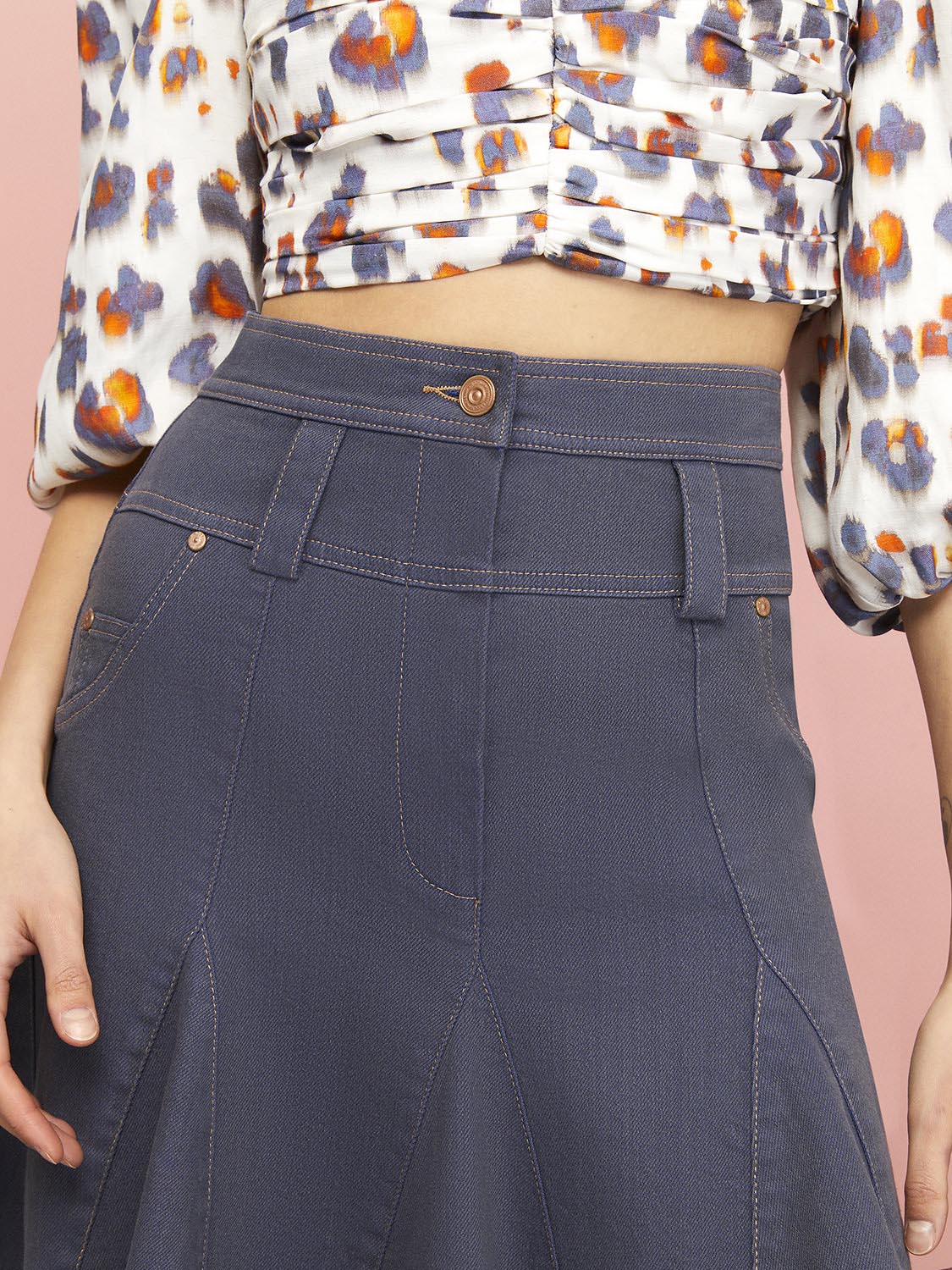 Flowing Mini Jean Skirt featuring a high-waisted design, flounced hem, and unique leopard print with orange accents.