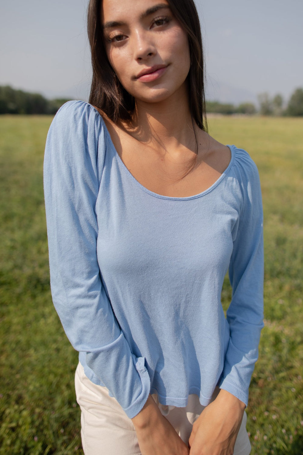 Flowy Tee in indigo and sky blue with puff shoulders and long sleeves, showcasing a scoop neck design.