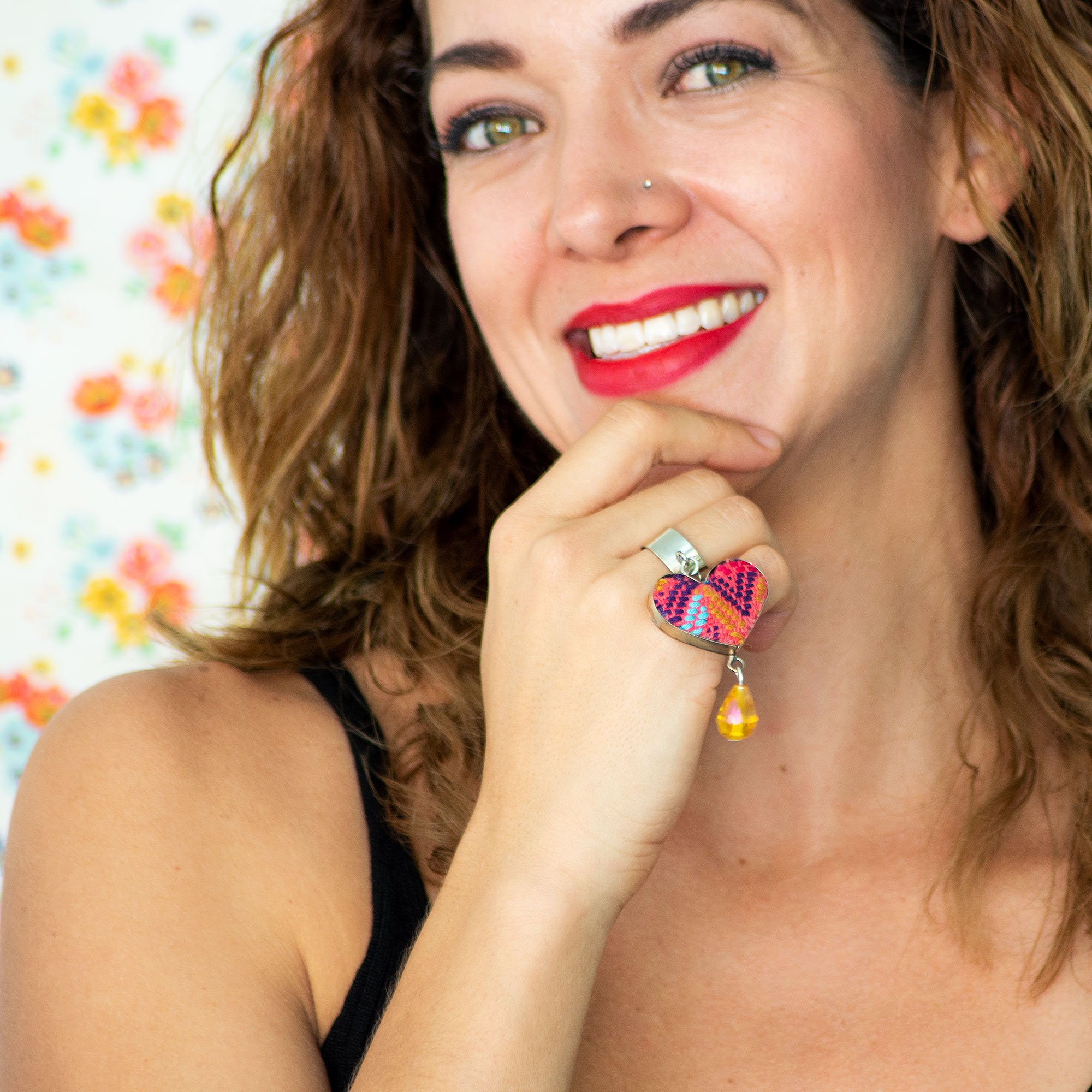 Folk Ring featuring a hanging heart pendant and colorful embroidered textile, handcrafted in Chiapas, Mexico.